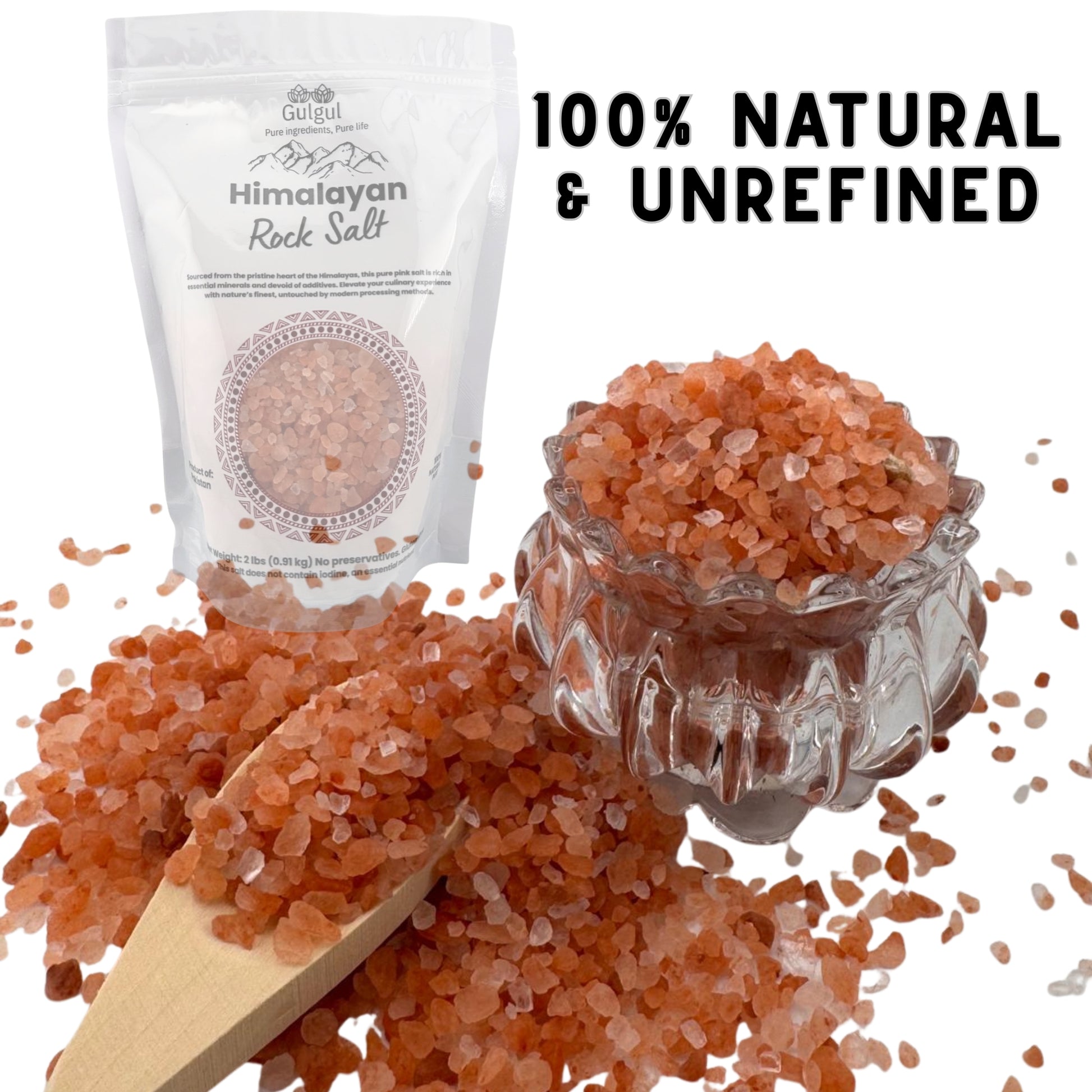 Coarse pink Himalayan salt with grinder and fresh ingredients for gourmet cooking